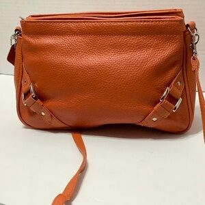 Leather purse orange three divider on top. Opening . Cross bage strap.